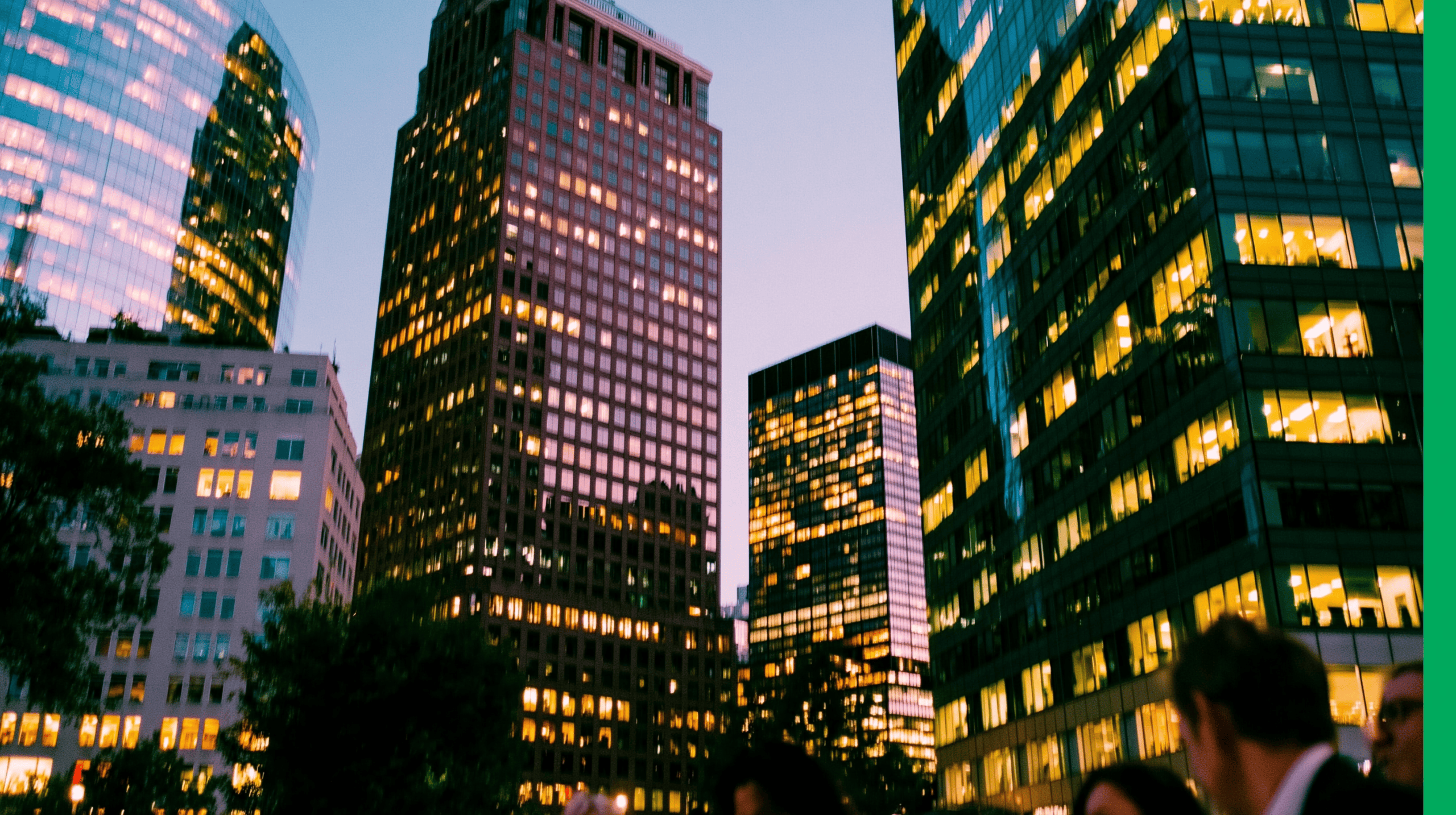 Skyscrapers with illuminated windows in a vibrant cityscape at dusk.